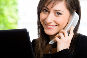 Picture of a smiling female talking on the phone.