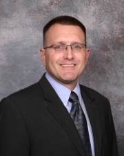 Dr. Brian Wilson D.O., Board Certified Psychiatrist, Board Certified Child Psychiatrist, and Chief Medical OfficerPicture of Dr. Brian Wilson D.O., Board Certified Psychiatrist, Board Certified Child Psychiatrist, and Chief Medical Officer in a dark gray suit