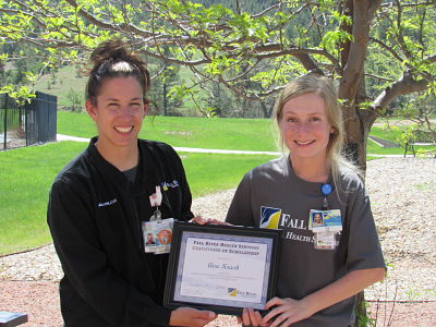 Picture of two females both holding a $1000 Scholarship that is being offered to a 2022 Fall River Health Services graduate who is planning to attending an accredited college, university, or trade school for an occupation in the Healthcare field. 