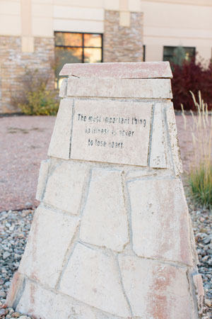 Picture of the hospital stone stating "The most important thing to illness is never to lose heart." 