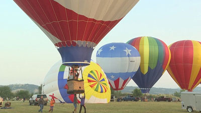 Picture of hot air balloons getting ready to lift up. 