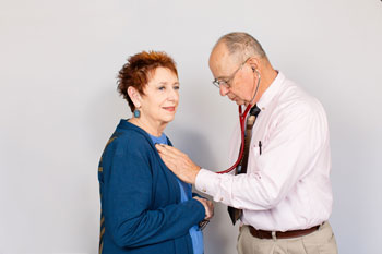 Picture of a doctor checking patients pulse. 