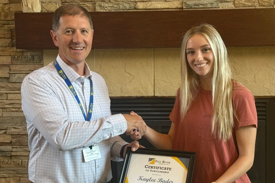 Picture of two females both holding a $1000 Scholarship that is being offered to a 2022 Fall River Health Services graduate who is planning to attending an accredited college, university, or trade school for an occupation in the Healthcare field. 
